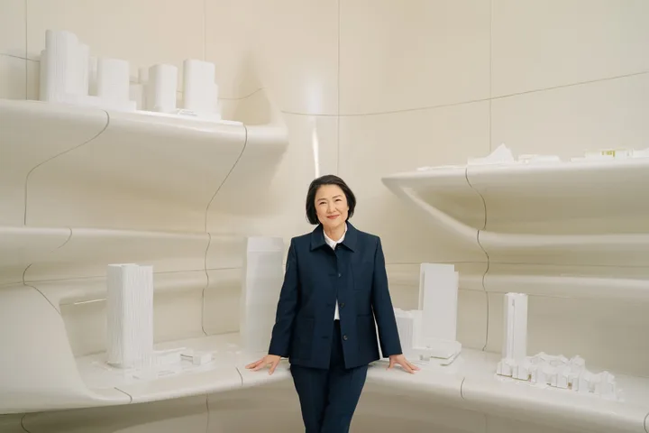 Zhang Xin stands with models of some of her past SOHO China projects in her office in New York City.