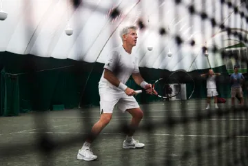 Ackman playing tennis.